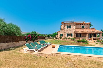 A large house with a swimming pool in front of it