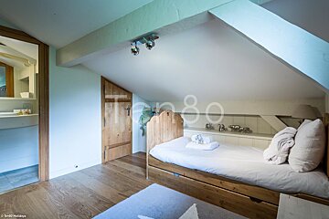 A bedroom with the number 80 on the wall