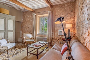 A living room with a stone wall and a couch
