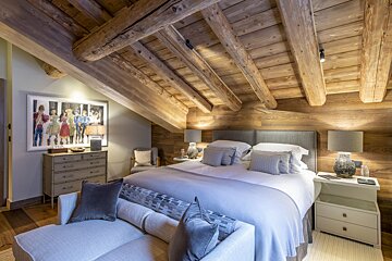 A bedroom with a large bed and a couch
