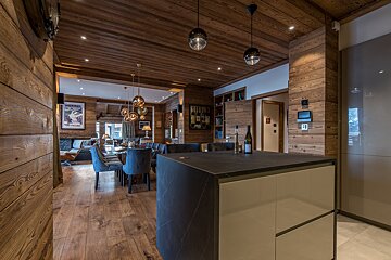 A kitchen with a bottle of wine on the counter