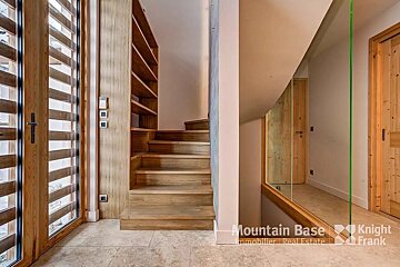 A hallway with stairs and a sign that says mountain base