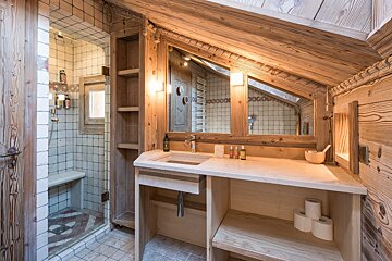 A bathroom with a sink and two rolls of toilet paper