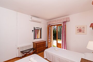 A bedroom with two beds a dresser and a mirror