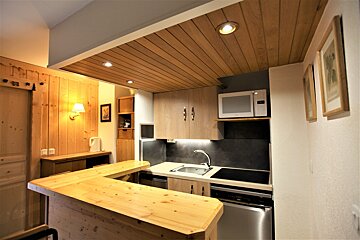 A small kitchen with a microwave and a sink