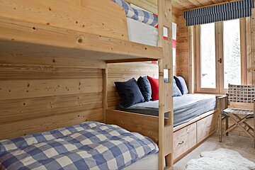 A bunk bed with a blue and white checkered comforter