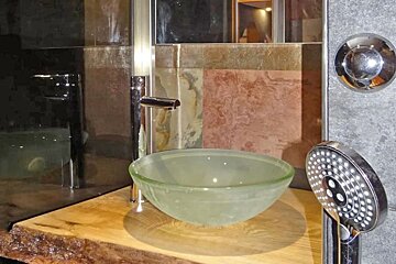 A bathroom with a sink and a shower head with the number 8 on it