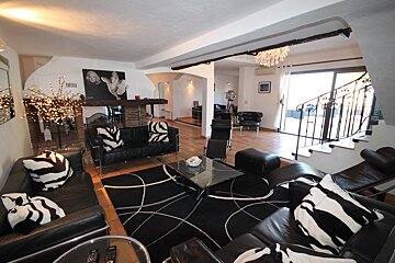A living room with black and white furniture and a fireplace