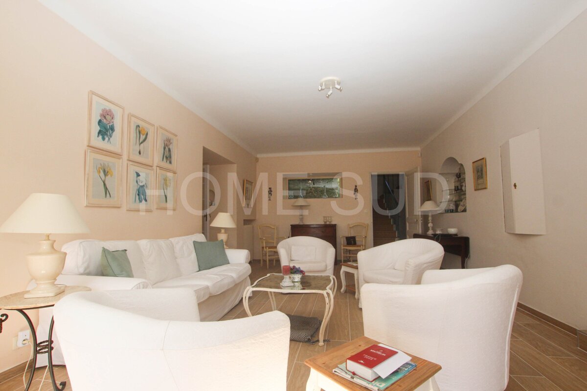 A living room with a couch and chairs and the word home on the wall