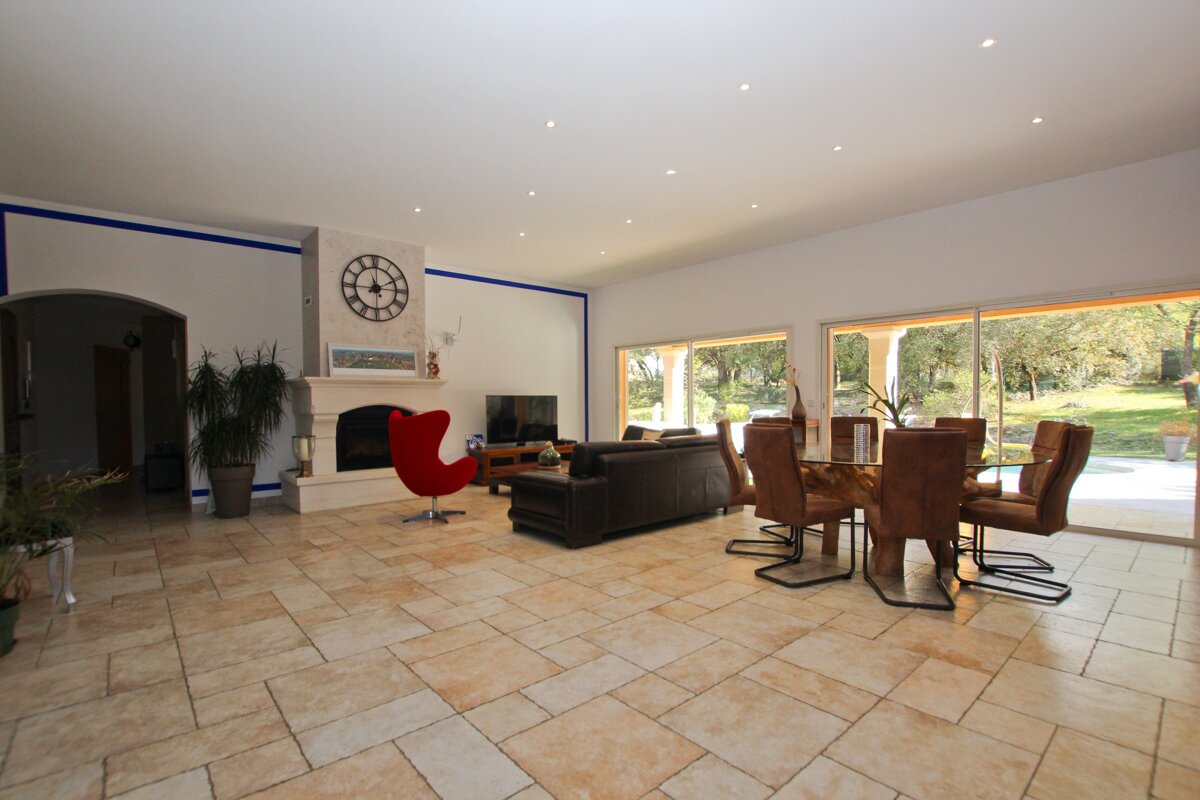 A living room with a fireplace and a clock on the wall