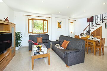 A living room with a couch a chair and a table