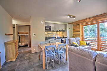 A living room with a couch and a table and chairs