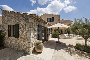 A stone building with an umbrella in front of it