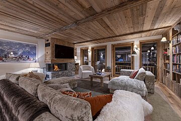 A living room with a couch a chair and a fireplace