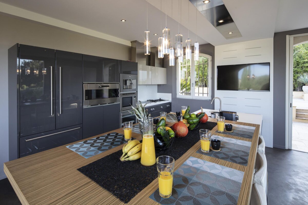A kitchen with a dining table and a bottle of orange juice