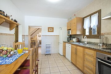 A kitchen with wooden cabinets and granite counter tops