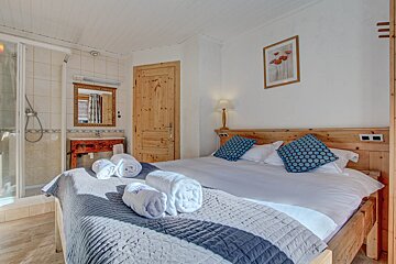 A bedroom with a bed and a picture on the wall