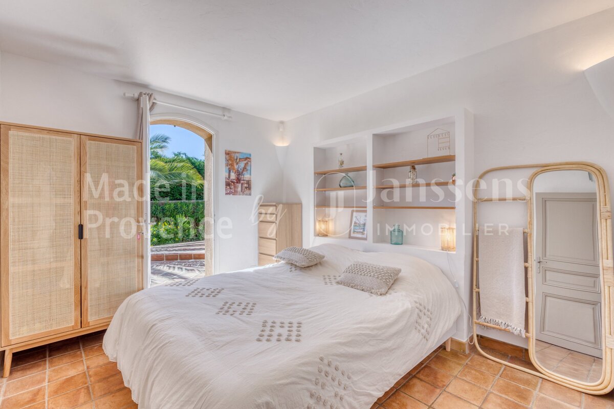 A bedroom with a bed and a mirror and the words made in provence on the wall