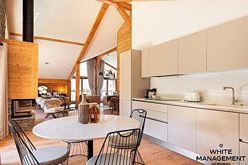 A living room with a couch a chair and a flat screen tv