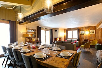 A dining room table with plates and bowls on it