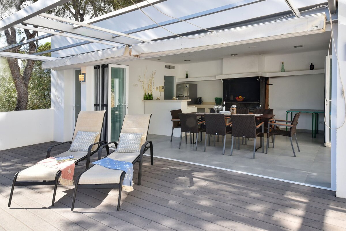 A dining room with a table and chairs and a sliding glass door