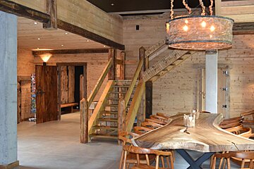 A wooden staircase leads up to the second floor
