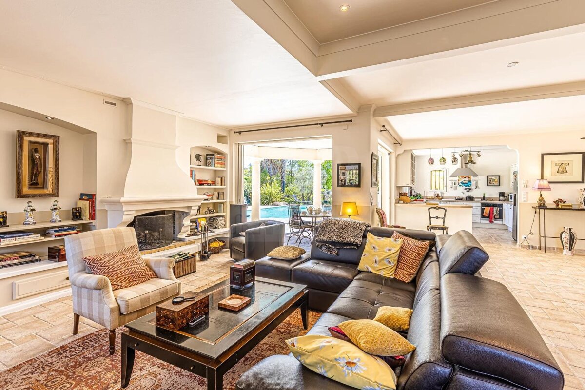 A living room with a couch and chairs and a fireplace