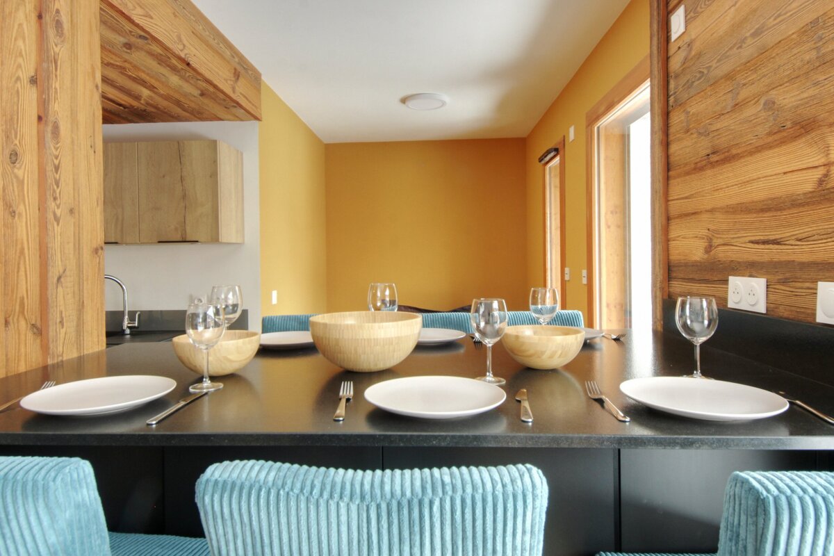 A table with plates bowls and wine glasses on it