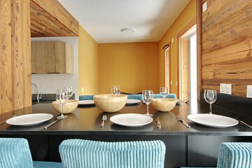 A table with plates bowls and wine glasses on it