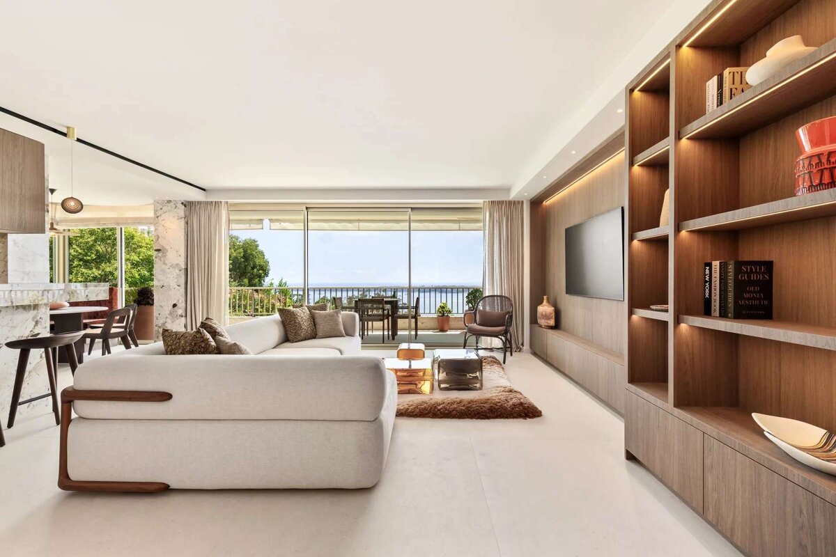 A living room with a white couch and a book titled style