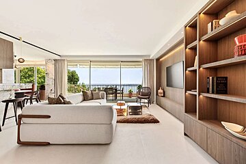 A living room with a white couch and a book titled style