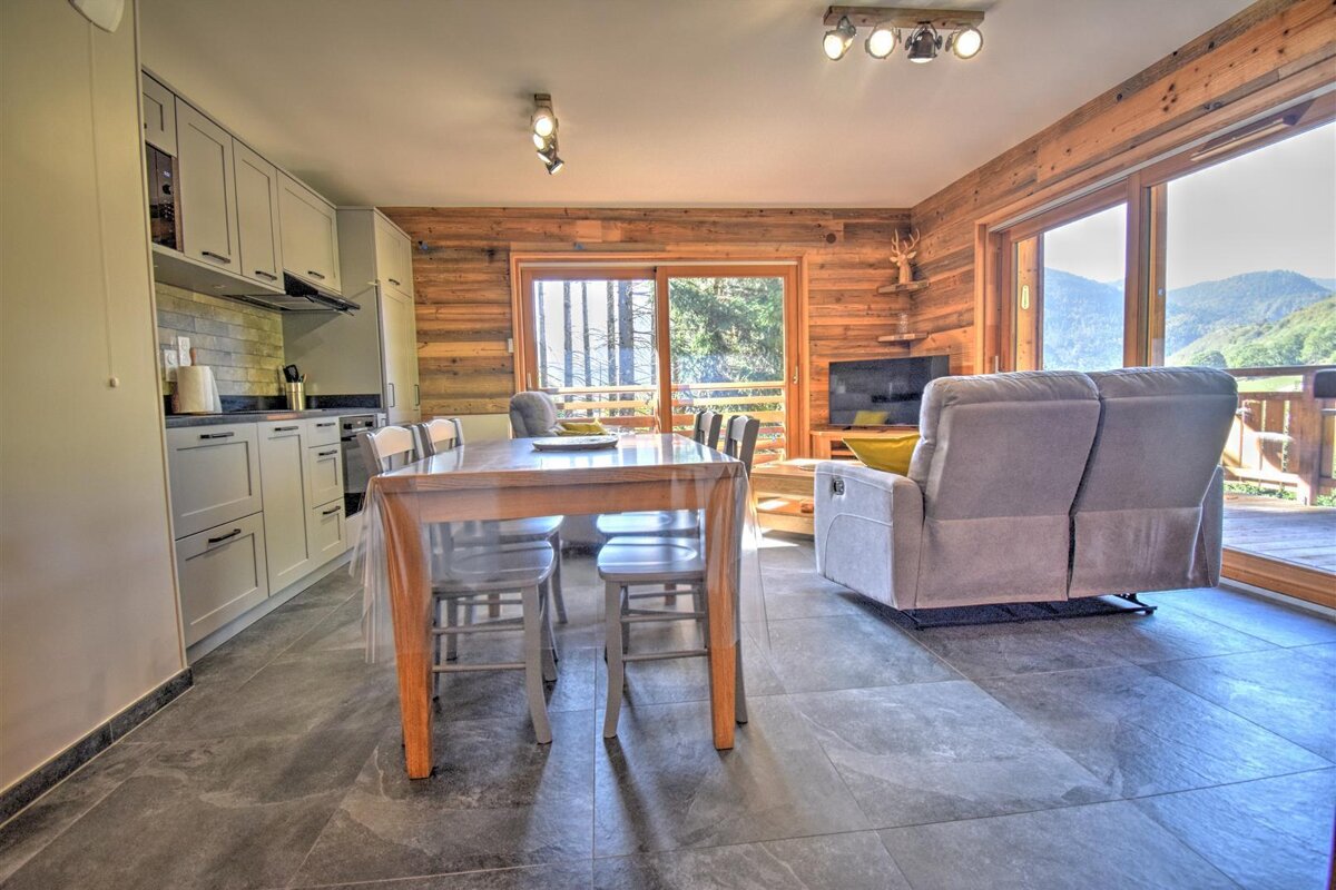 A living room with a table and chairs and a couch