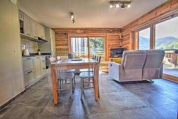 A living room with a table and chairs and a couch