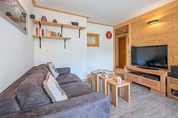 A living room with a couch and a flat screen tv