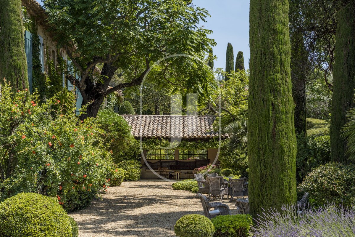 A lush green garden with a house in the background