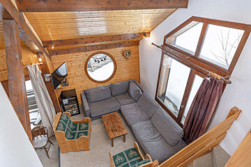 A living room with a couch and a television