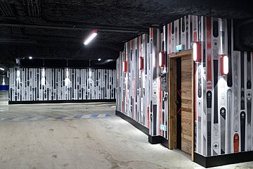 A hallway in a building with skis on the wall