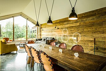 A dining room with a wooden table and chairs