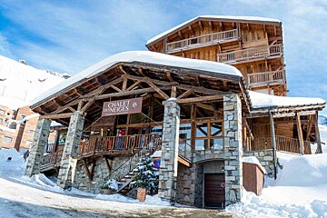 A snow-covered wooden and stone 