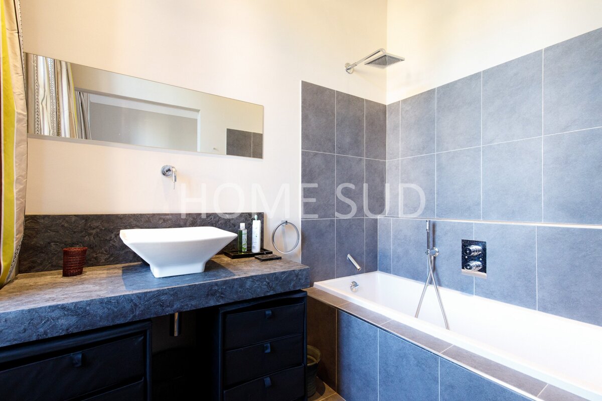 A bathroom with a sink and a bathtub that says home sud