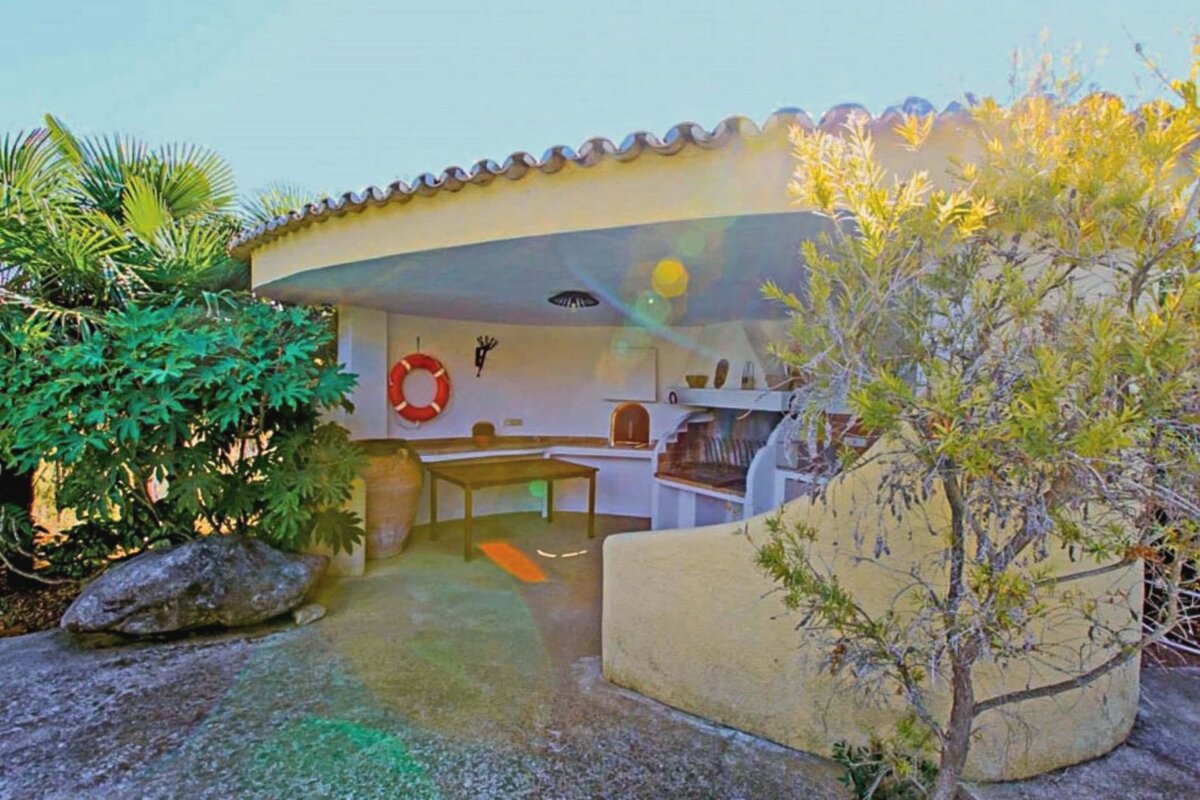 A bbq area with a life preserver on the wall