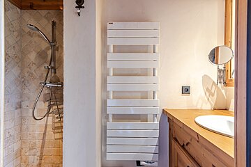 A bathroom with a towel rack and a mirror