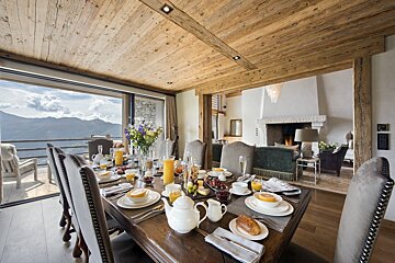 A dining room table with a view of the mountains