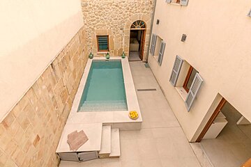 A small swimming pool in the backyard of a house