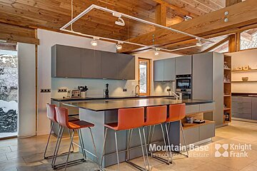 A kitchen with stools and a sign that says mountain base