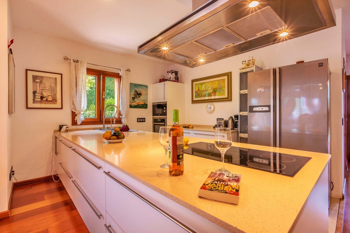 A bottle of wine sits on a kitchen counter next to a book about star wars