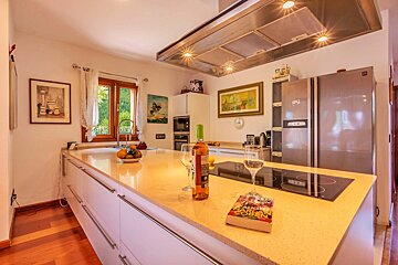 A bottle of wine sits on a kitchen counter next to a book about star wars