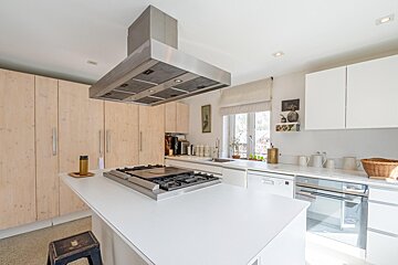 A kitchen with stainless steel appliances and white cabinets