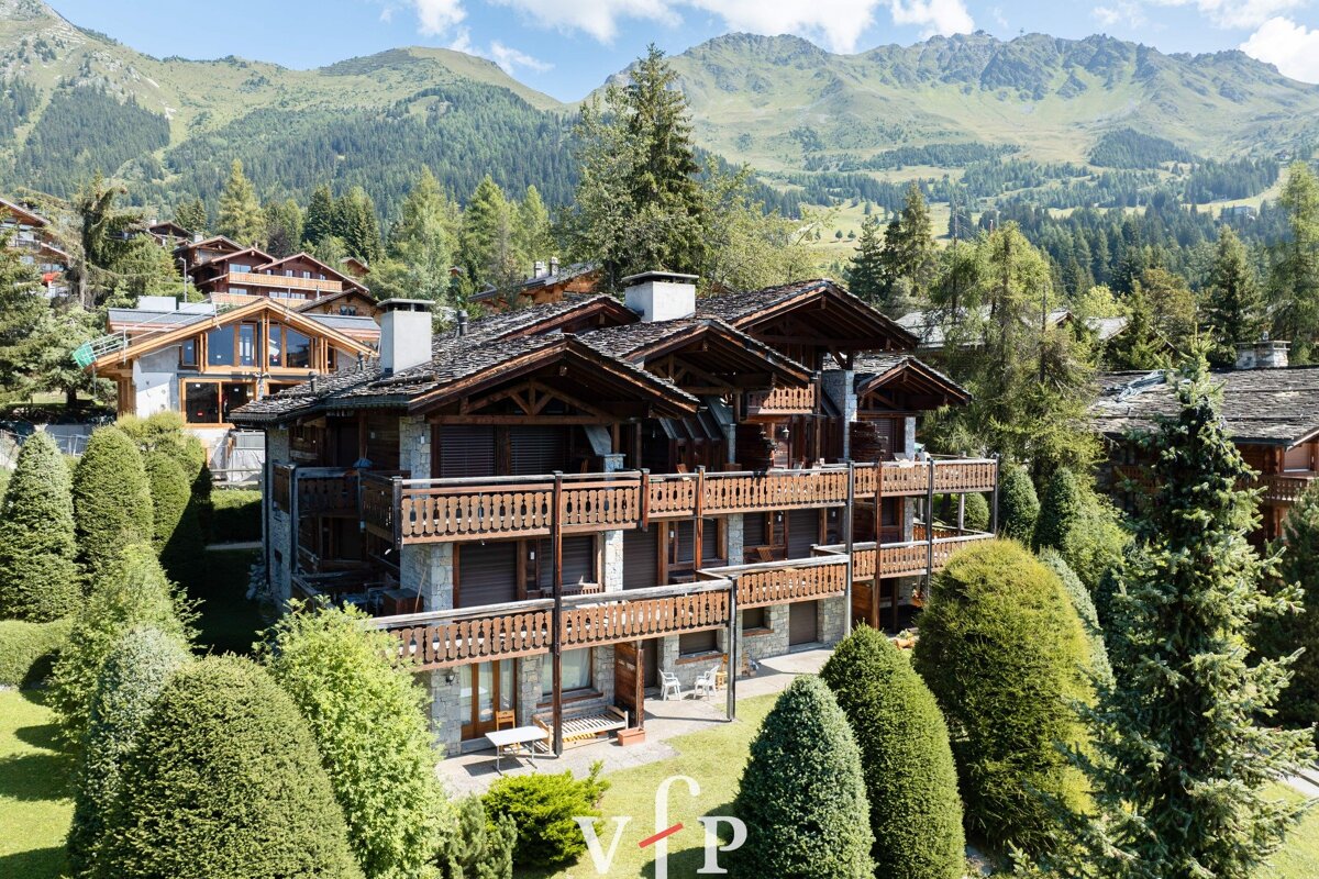 An aerial view of a chalet with the vip logo in the foreground
