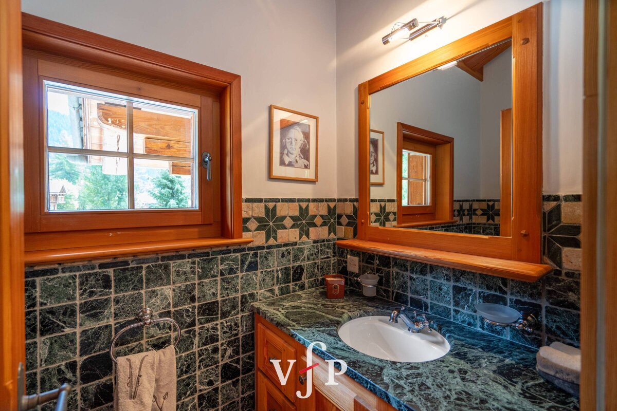 A bathroom with a sink and a mirror with the letters vjp on the counter
